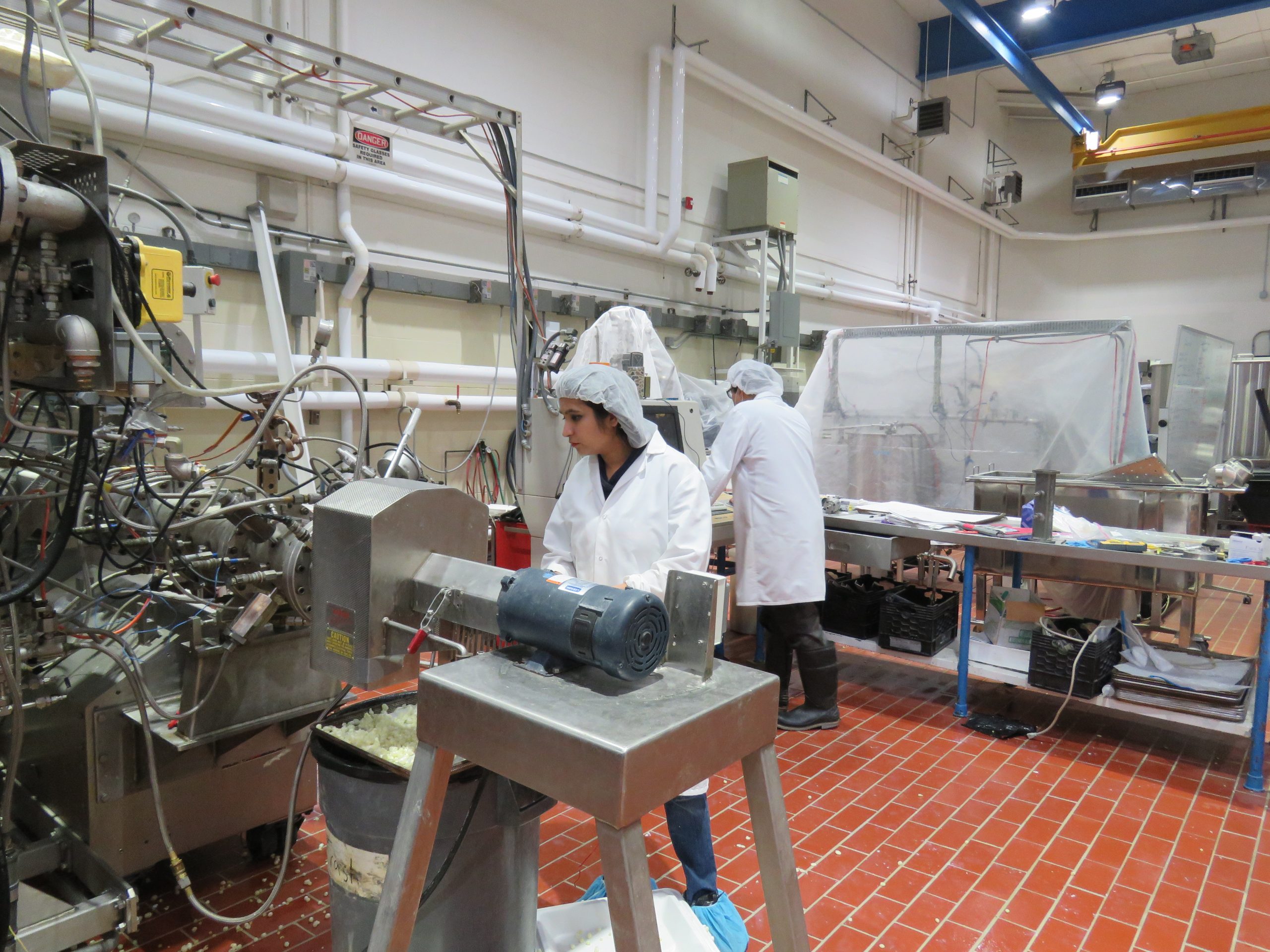 Bindvi Arora stands behind an extruder machine