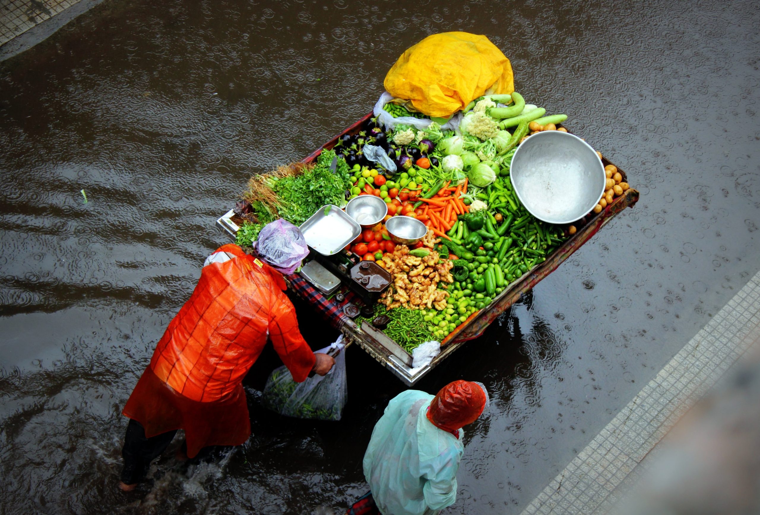 two people pushing food cart