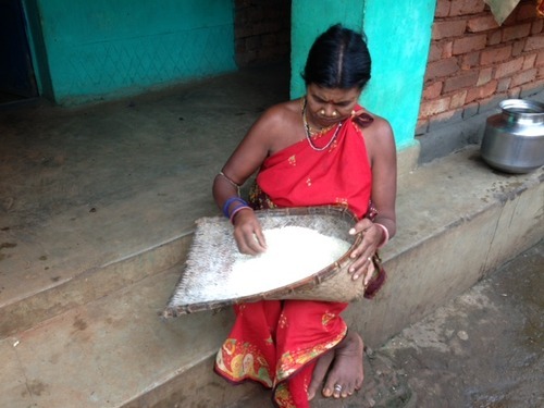 woman picking through a bushel of grains