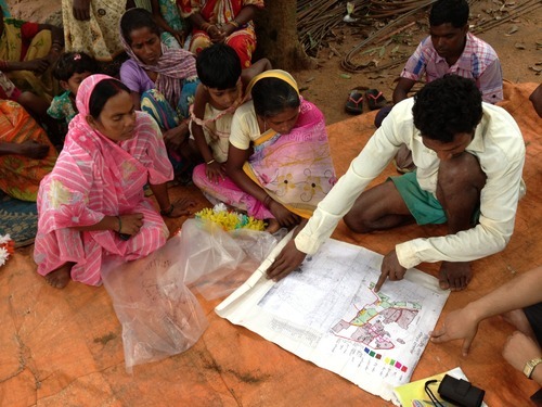 group of people looking at a map