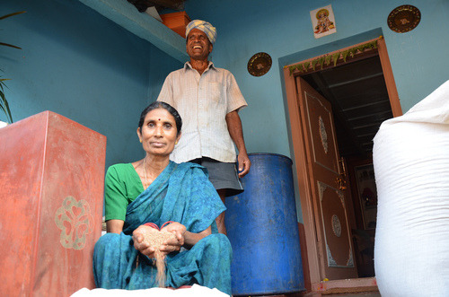 woman sitting letting grain run through her hands