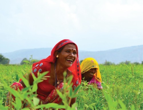 women smiling in field