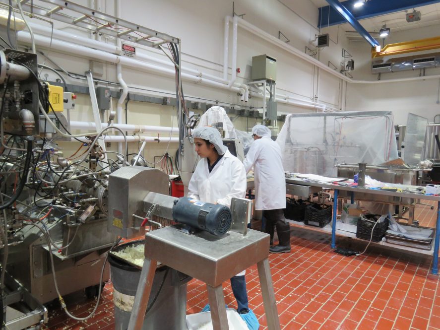 Bindvi Arora standing behind an extruder machine