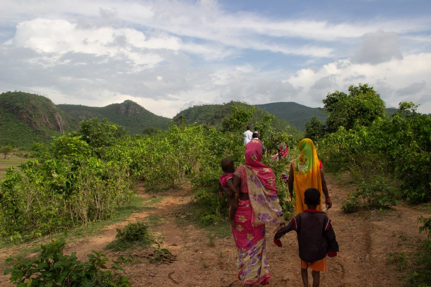 Women and children walking on a farm