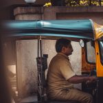 a man sitting in a motorized rickshaw