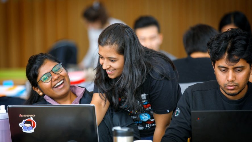 Students with computers working together