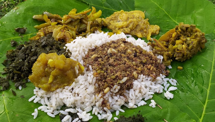 Cooked rice and vegetables on a leaf