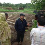 Prabhu Pingali speaking with people on a farm