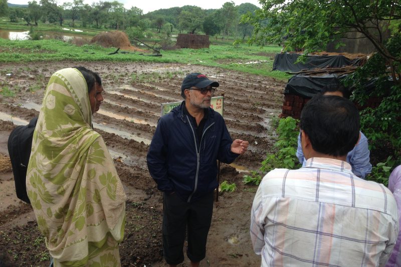 Prabhu Pingali speaking with people on a farm
