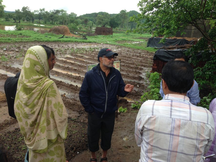 Prabhu Pingali speaking with people on a farm