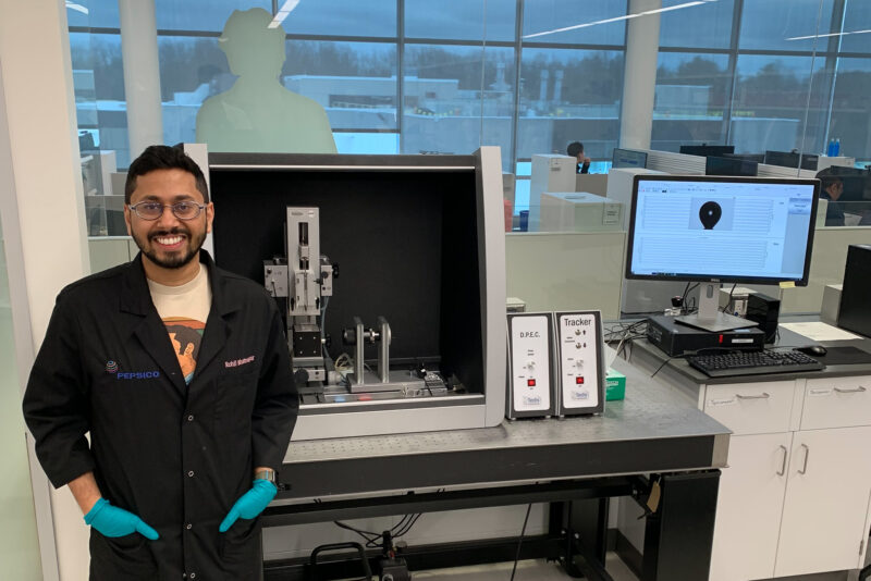 Rohil Bhatnagar standing in a lab