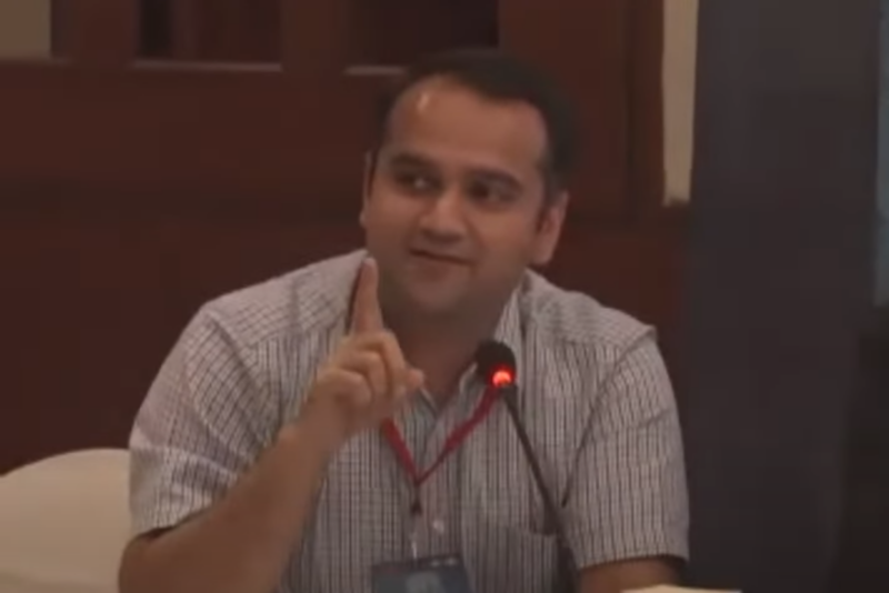Raghav Puri speaking into a microphone
