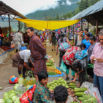 People shop at a farmers’ market.