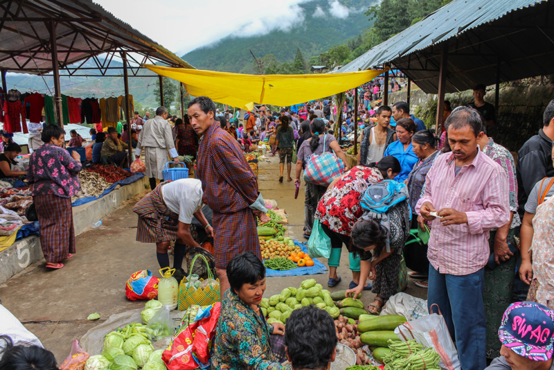 People shop at a farmers’ market.