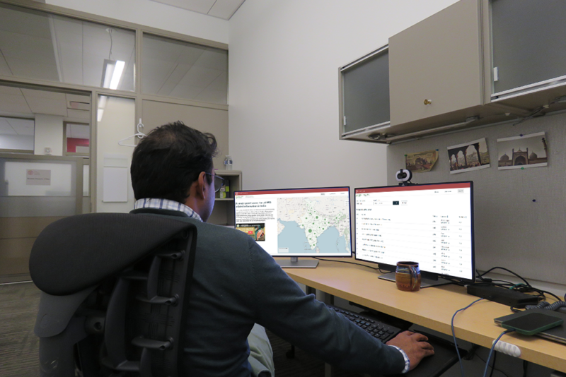 A man looking at the FPO database on two computer monitors