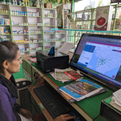 A farmer looks at the FPO database on her computer