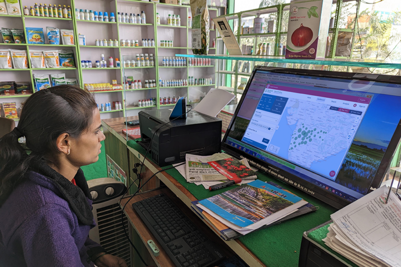 A farmer looks at the FPO database on her computer