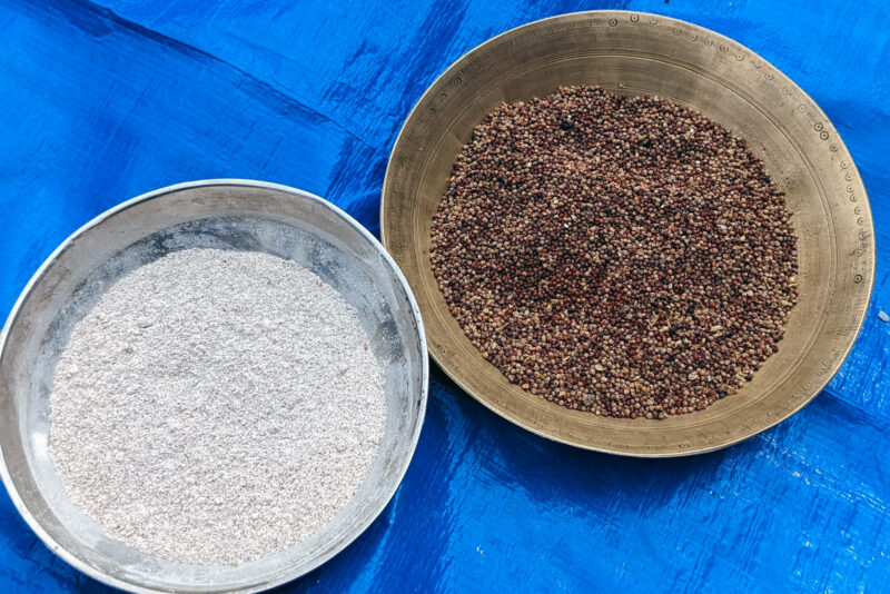Bowls of millets and millet flour on a blue tarp