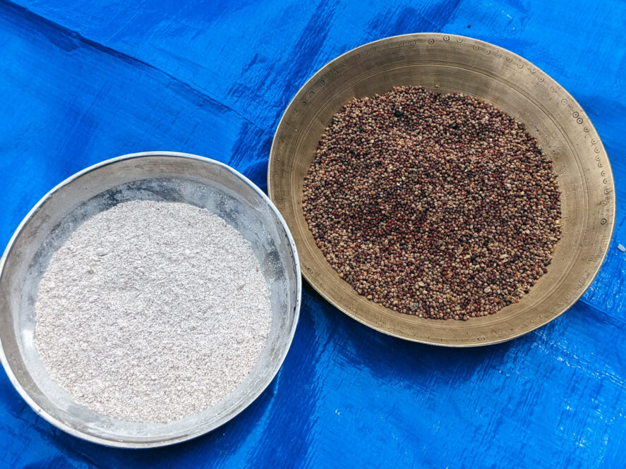 Bowls of millets and millet flour on a blue tarp
