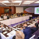 Attendees of TCI's PDS event sit at conference room tables