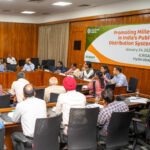 A group of people sitting around a conference room