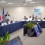 Men and women sitting at tables during the OPSAa workshop