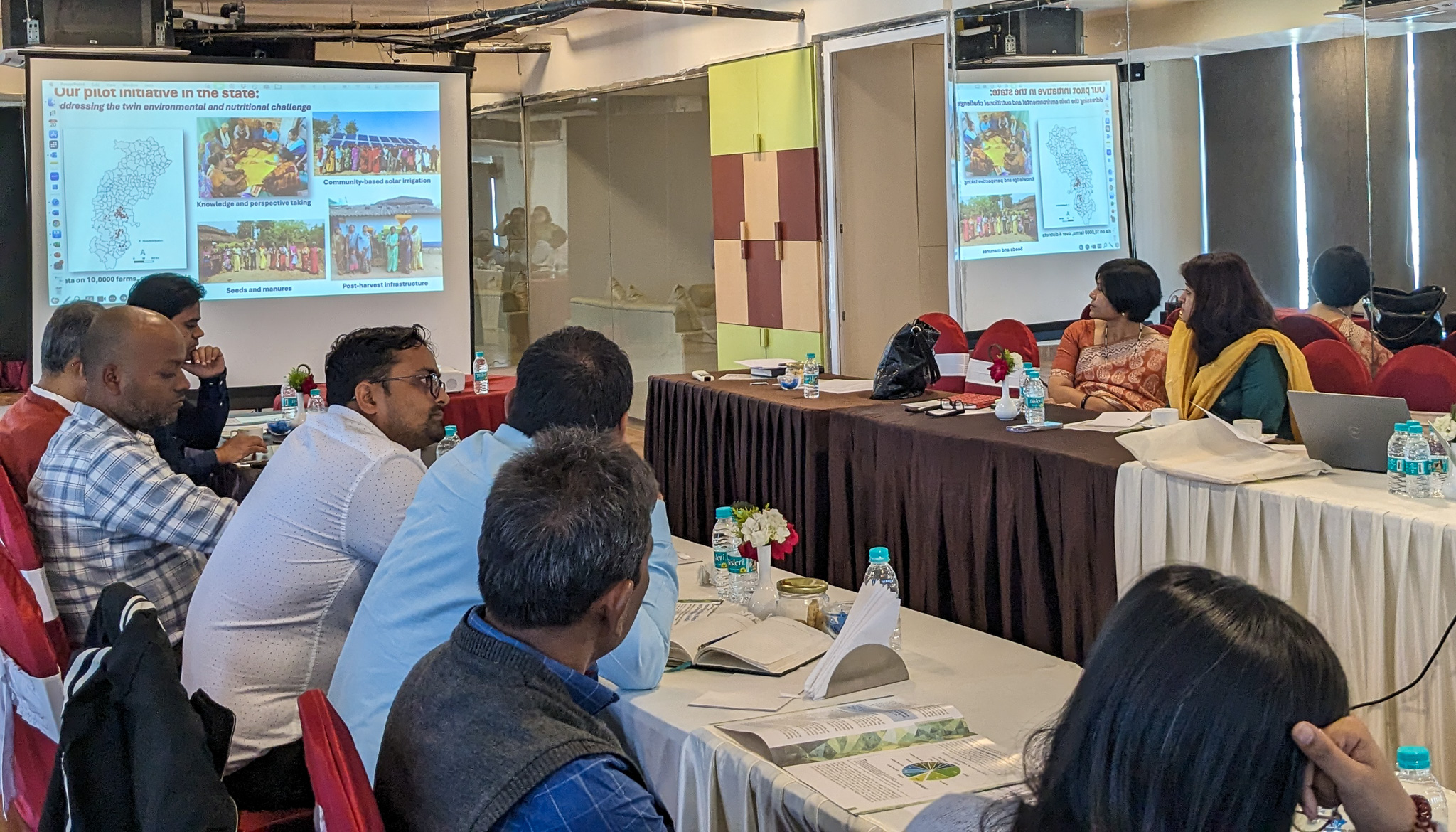 Researchers and government officials sitting during a presentation at the TCI-PRADAN workshop