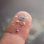 Bits of microplastic on a fingertip