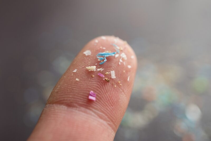 Bits of microplastic on a fingertip
