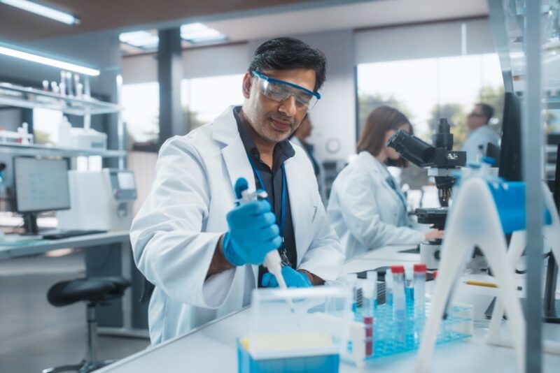 A scientist using a micropipette in a laboratory