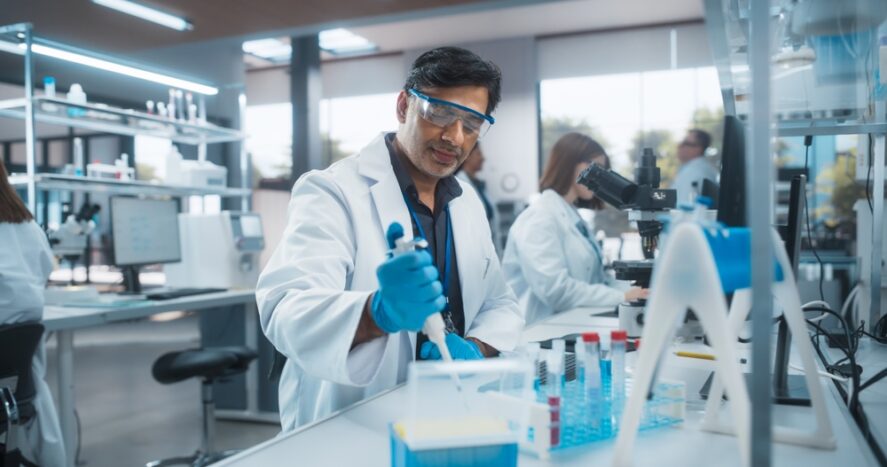 A scientist using a micropipette in a laboratory
