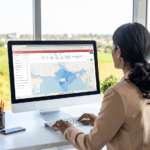 A business woman looking at a map of FPOs in India on her computer