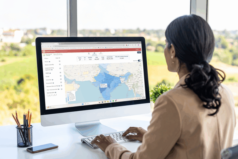A business woman looking at a map of FPOs in India on her computer