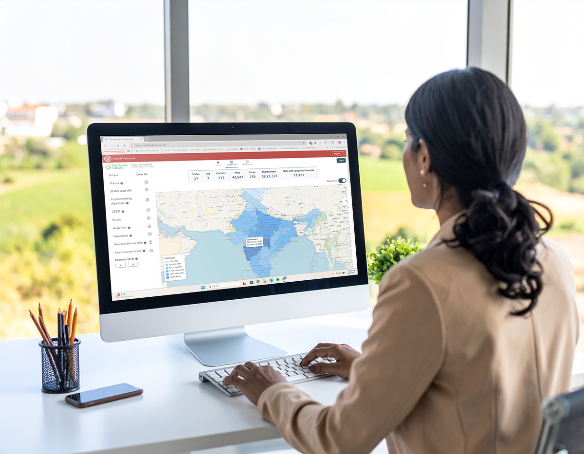 A business woman looking at a map of FPOs in India on her computer
