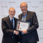 Harold van Es receiving an award