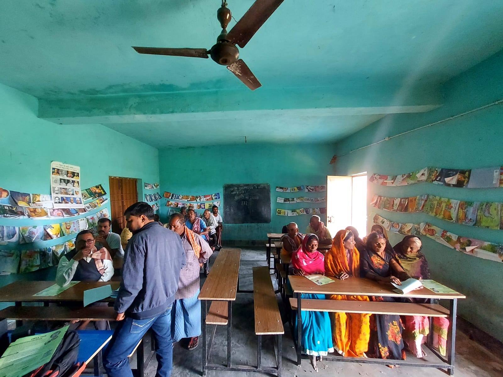 A group of people meeting in a school room