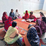 Annie Kaur sitting in a circle with a group of women